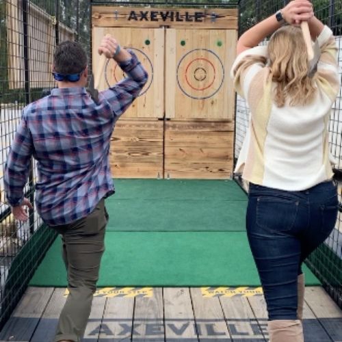 Couple throwing axes in two different targets