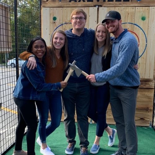 Group photo of young people after having fun axe throwing at axville